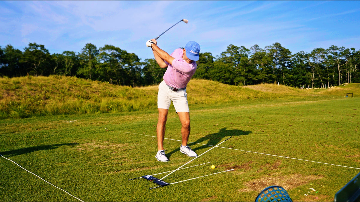 Tour Aim 3.0 set up on the range with an alignment stick through the Path Hole